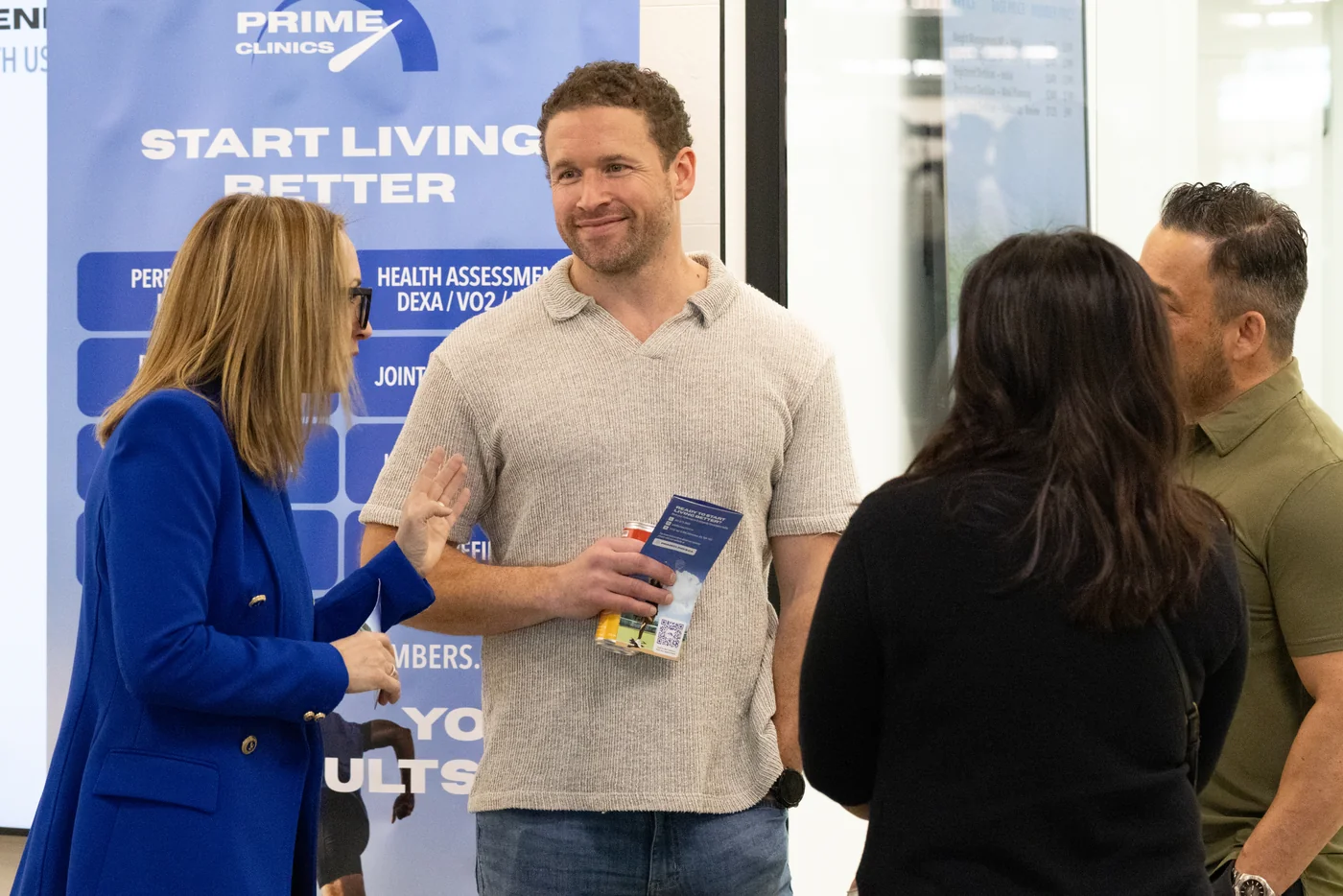 PRIME Clinics team speaking with visitors at a clinic event