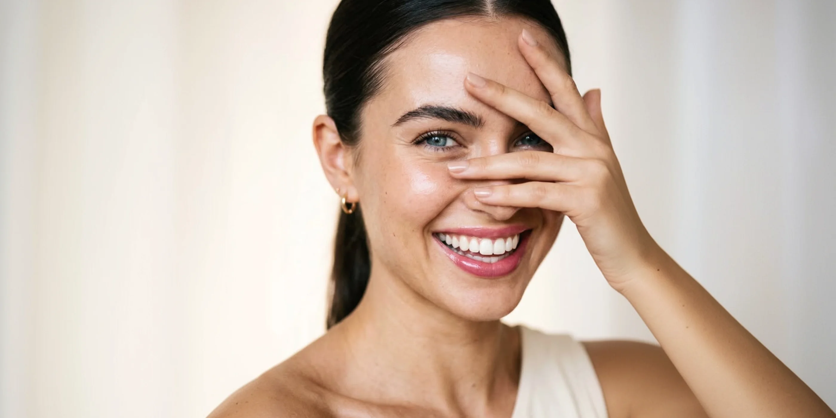 Client with radiant, healthy skin after a treatment at Prime Clinics